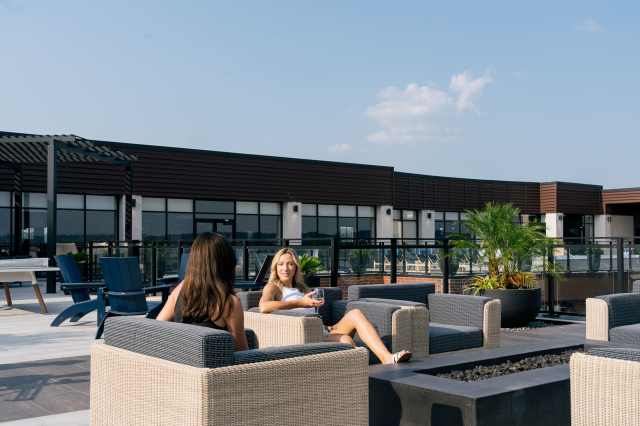 two people at the fire pit at the oxbow rentals north kansas city